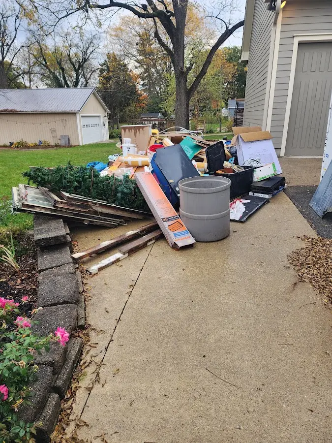 Dumpster being loaded with debris for Roofing Dumpster Rental in Adel